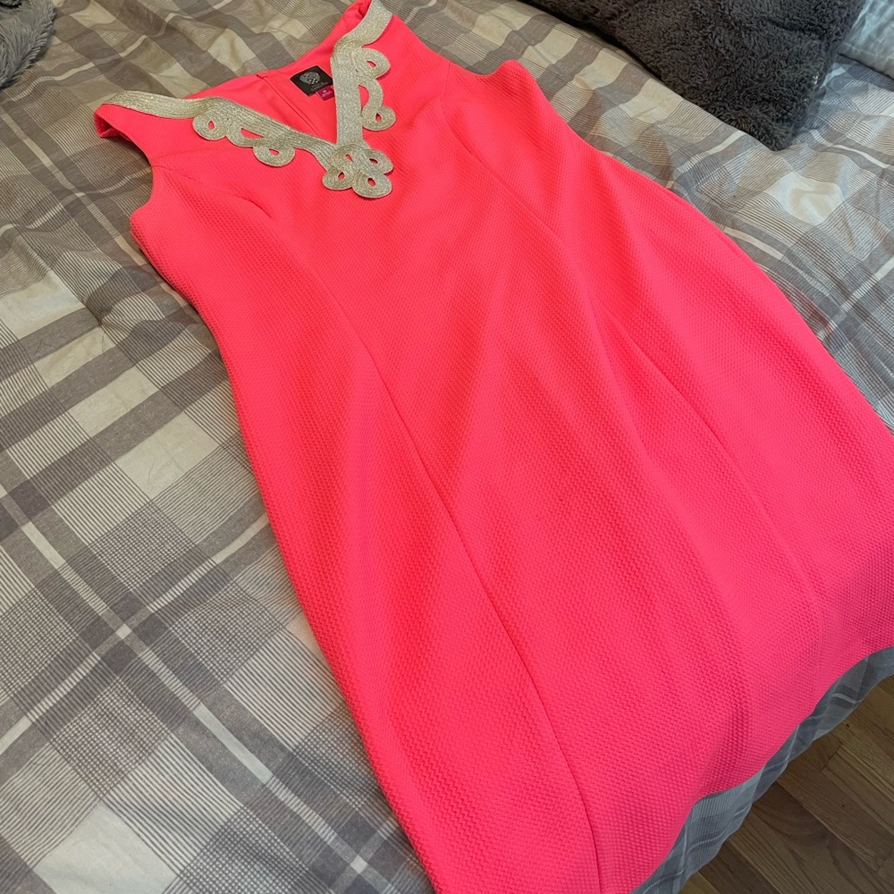 Bright pink dress with platinum detail around neck